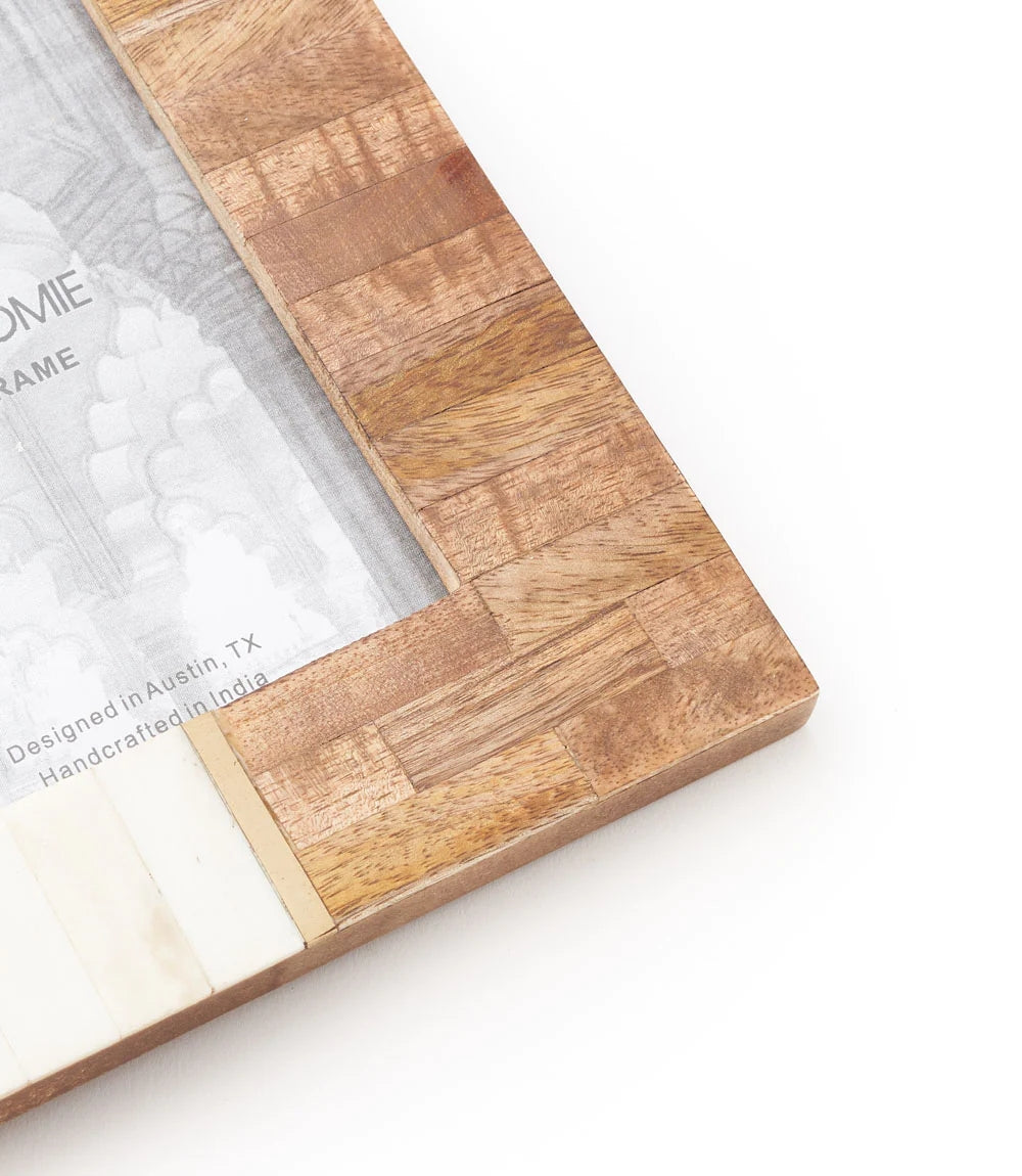 4 x 6. This handcrafted frame features cruelty free bone on one side and sustainably sourced mango wood on the other, with brass accents. For convenient display this frame features a table top easel and d-ring for hanging. All of Matr Boomie's collection is handmade, fair trade and sustainable.