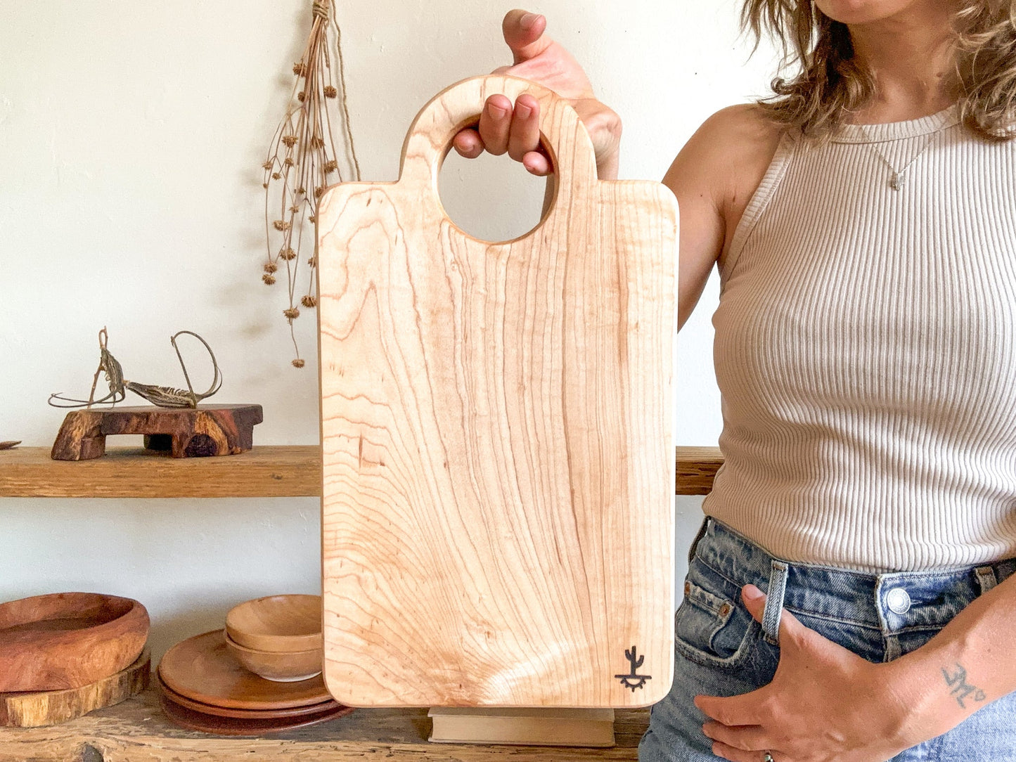 A modern design featuring a circular handle. These are made out of either hard maple that is know for its neutral grain and durable surface or dark walnut that is know for its moody grain with stripes of caramel. Great boards to grab for a quick chop or made as your designated home bar board for citrus.