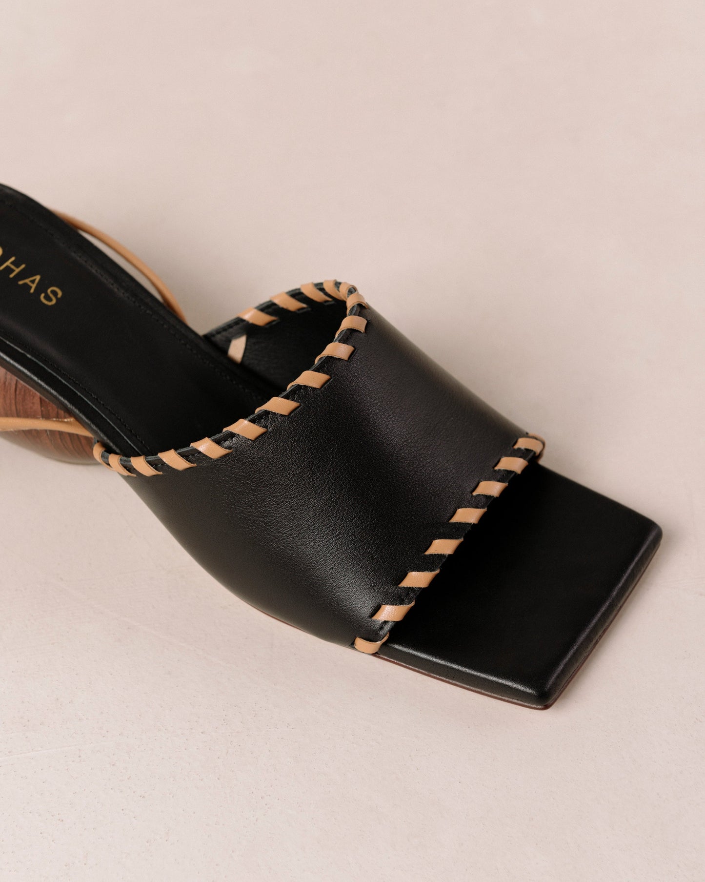 Thanks to their rounded mid heel and thick front strap, these chic lace-up sandals strike a balance between comfort and flair. Crafted from premium black leather, they have long, slim straps which wrap delicately around the ankle for a secure fit. Sustainably made in Spain. Alohas Kitty Black Leather Sandal.