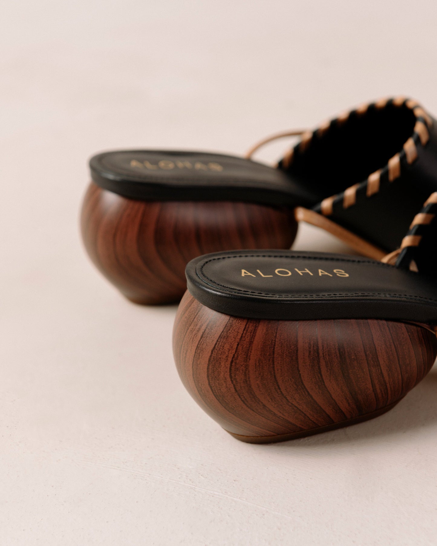 Thanks to their rounded mid heel and thick front strap, these chic lace-up sandals strike a balance between comfort and flair. Crafted from premium black leather, they have long, slim straps which wrap delicately around the ankle for a secure fit. Sustainably made in Spain. Alohas Kitty Black Leather Sandal.