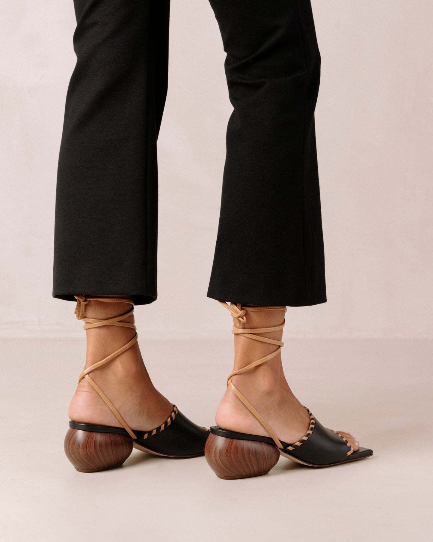 Thanks to their rounded mid heel and thick front strap, these chic lace-up sandals strike a balance between comfort and flair. Crafted from premium black leather, they have long, slim straps which wrap delicately around the ankle for a secure fit. Sustainably made in Spain. Alohas Kitty Black Leather Sandal.