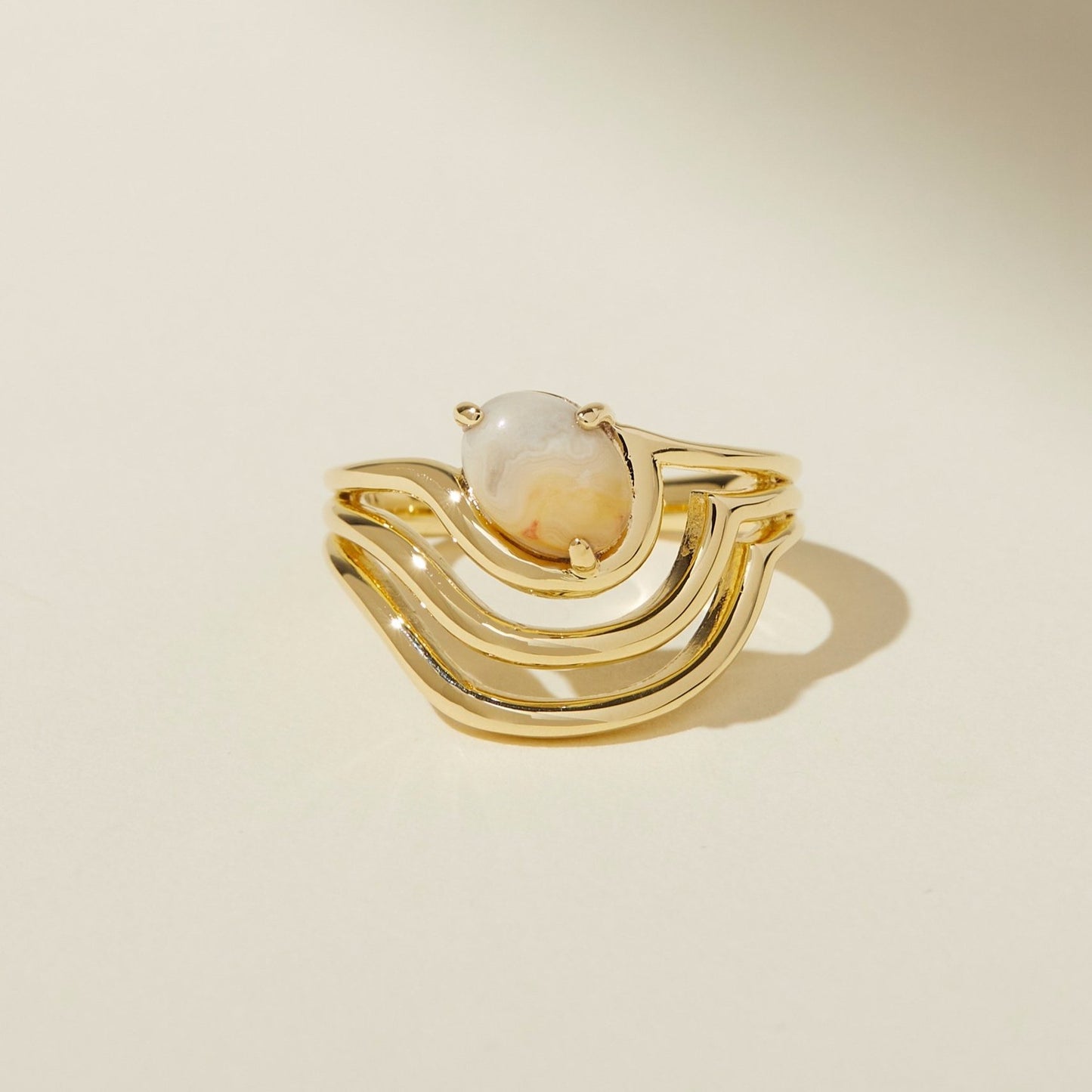 The sway ring features curved lines that flow around a diagonal set crazy lace agate stone. Updated style tapers the underside of the band for a very comfortable fit, rounding all the edges, and dipping it in gold for a bright shine. Handmade by Lindsay Lewis.