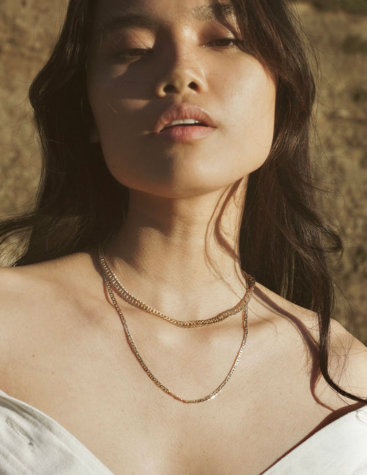 A simple braided chain intended to provide a ring of protection and luck when worn. 18k gold filled chain. Handmade in the Santa Cruz Mountains.