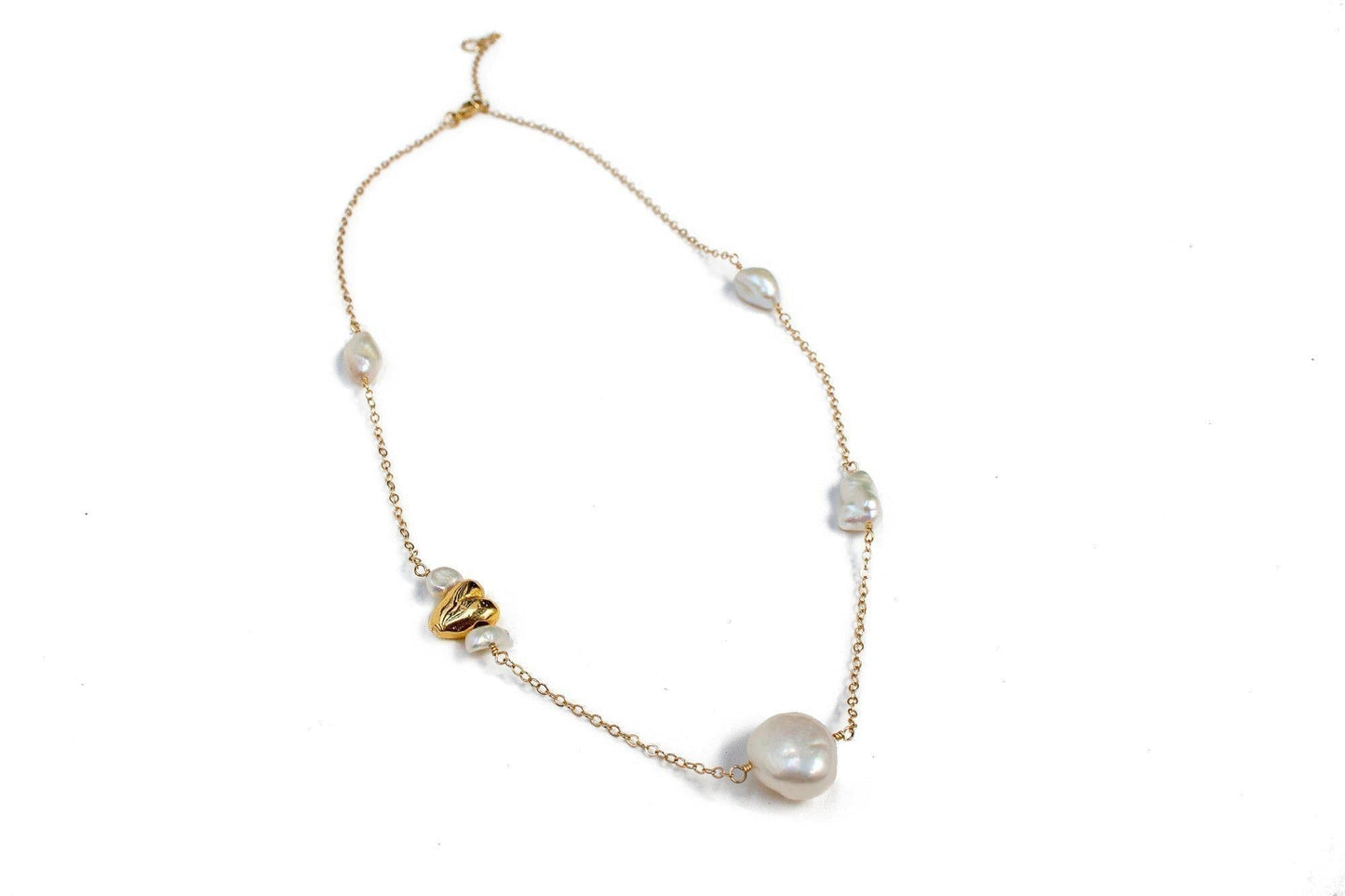 This satellite necklace includes varying sizes of baroque freshwater pearls and a gold accent heart. The perfectly imperfect pearls are connected with a 14k gold fill chain and hand-wrapped wire. All Dea Dia pieces are designed and handmade in Downtown Los Angeles.