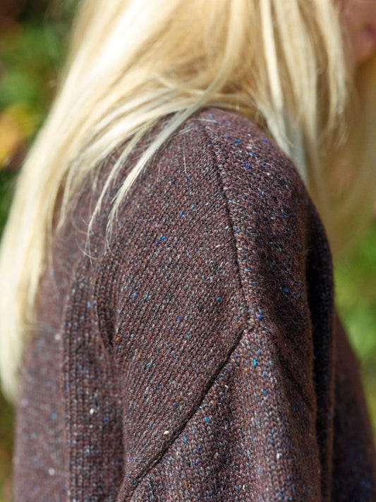 Close-up of a textured brown fabric with a blurred background. Mollusk Surf Shop Rhys Sweater