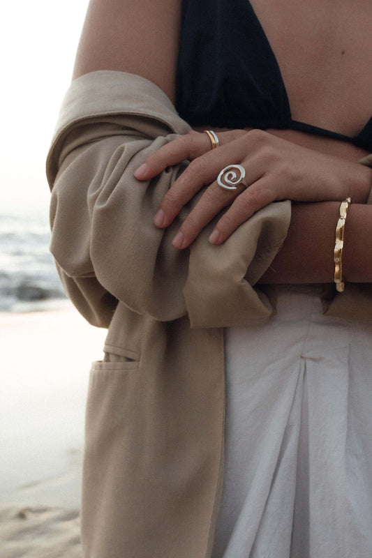 This statement ring is inspired by the fluid and mesmerizing movement of seaweed underwater. Hand carved and cast with a high polish mirror finish. Each swirl is a bit unique in shape. Available in solid brass or sterling silver.