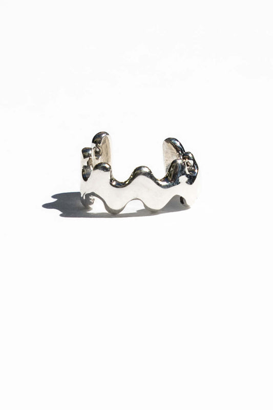 This ear cuff is inspired by the frilly wavy blade of wakame seaweed. Perfect for wearing a layered earring look without needing a piercing. Hand carved and cast with a high polished mirror finish. Available in solid brass or sterling silver.