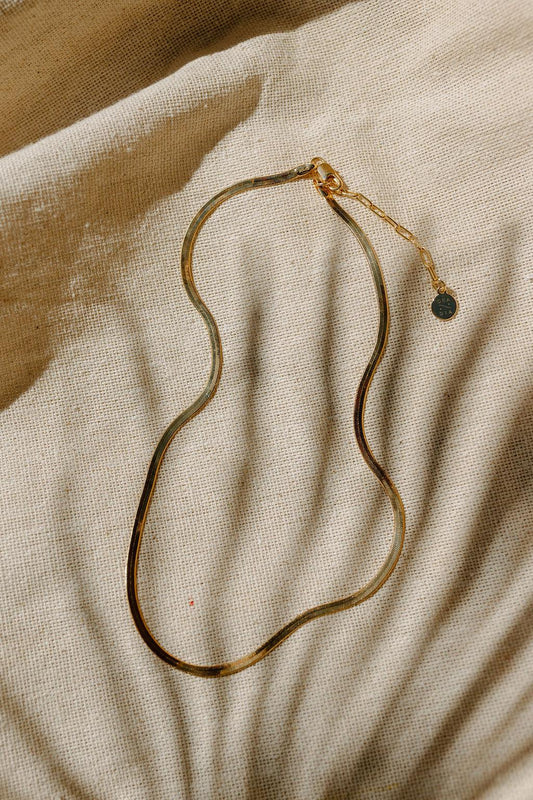 Liquid gold best describes this necklace. Flat Herringbone chain catches the light and sits on your skin in the most graceful and slinky way. Dea Dia sold at Thread Spun.