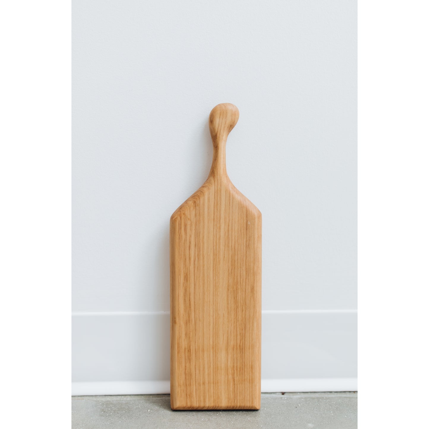 Hand-crafted cheeseboard perfect for a small sampling of cheese or appetizers. The handle is perfect for carrying to the table, and adds visual interest. Made sustainably from maple wood in Gatineau, Canada.