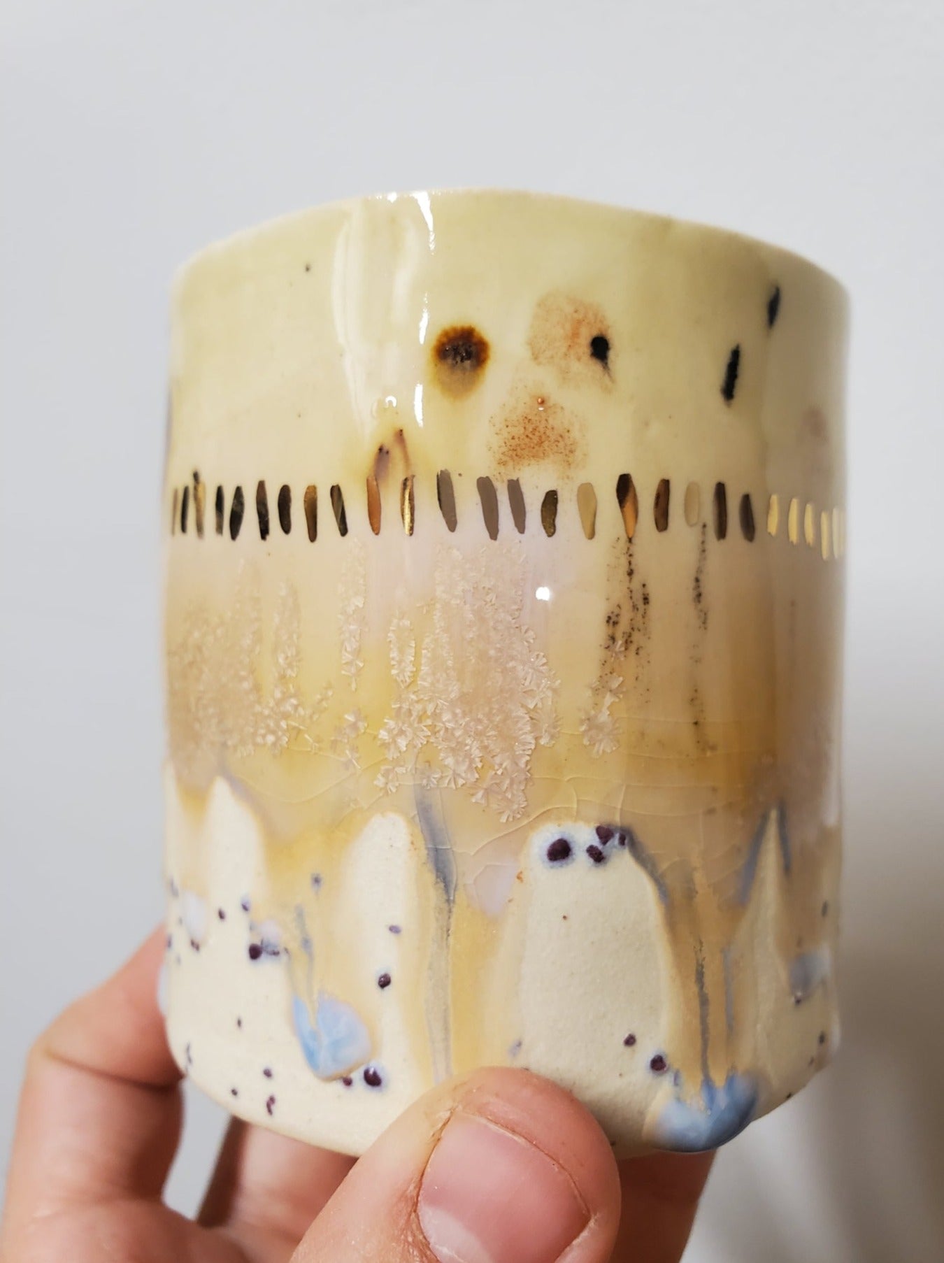 Handmade ceramic tumbler that is just perfect for all of your entertaining needs (including cocktails). Features gold luster accents for all of your celebrations and sure to impress.