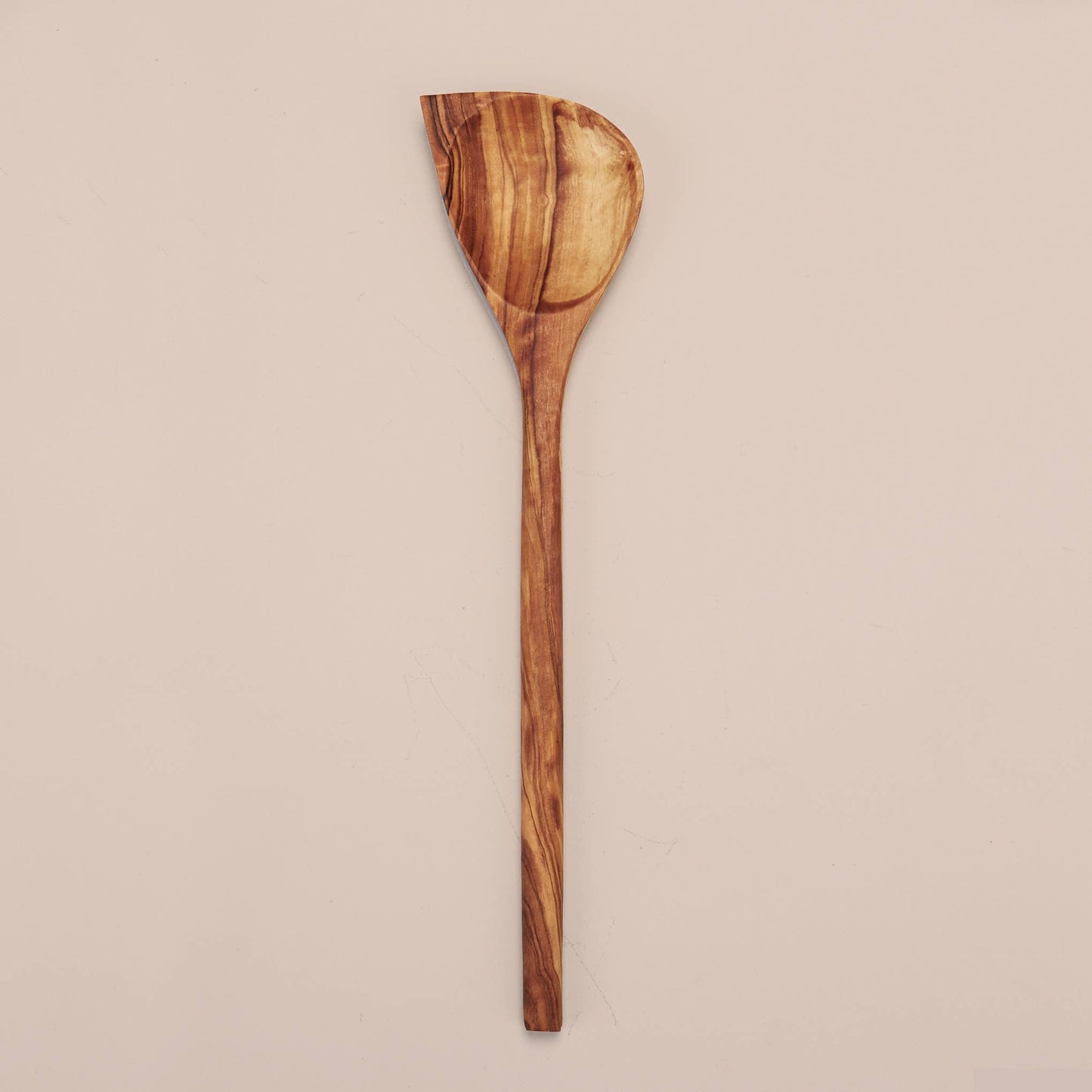 Handcrafted in Tunisia using natural olive wood from the region, this corner spoon kitchen utensil is hard, durable and non porous. Each piece is unique and becomes even darker, richer and more beautiful in color as it ages.