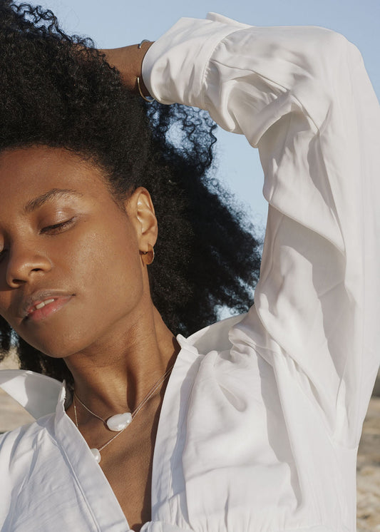 Bora Hoops by Amanda Hunt. A smooth yet slightly textured hoop. Light as a feather. Available in hand cast sterling silver with sterling silver posts or hand cast yellow bronze.