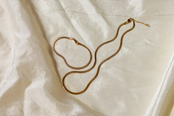 Liquid gold best describes this necklace. Flat Herringbone chain catches the light and sits on your skin in the most graceful and slinky way. Dea Dia sold at Thread Spun.