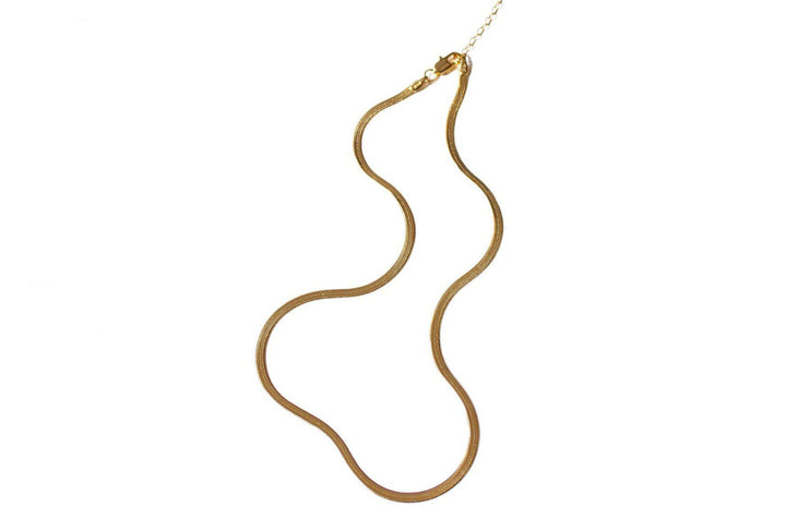 Liquid gold best describes this necklace. Flat Herringbone chain catches the light and sits on your skin in the most graceful and slinky way. Dea Dia sold at Thread Spun.