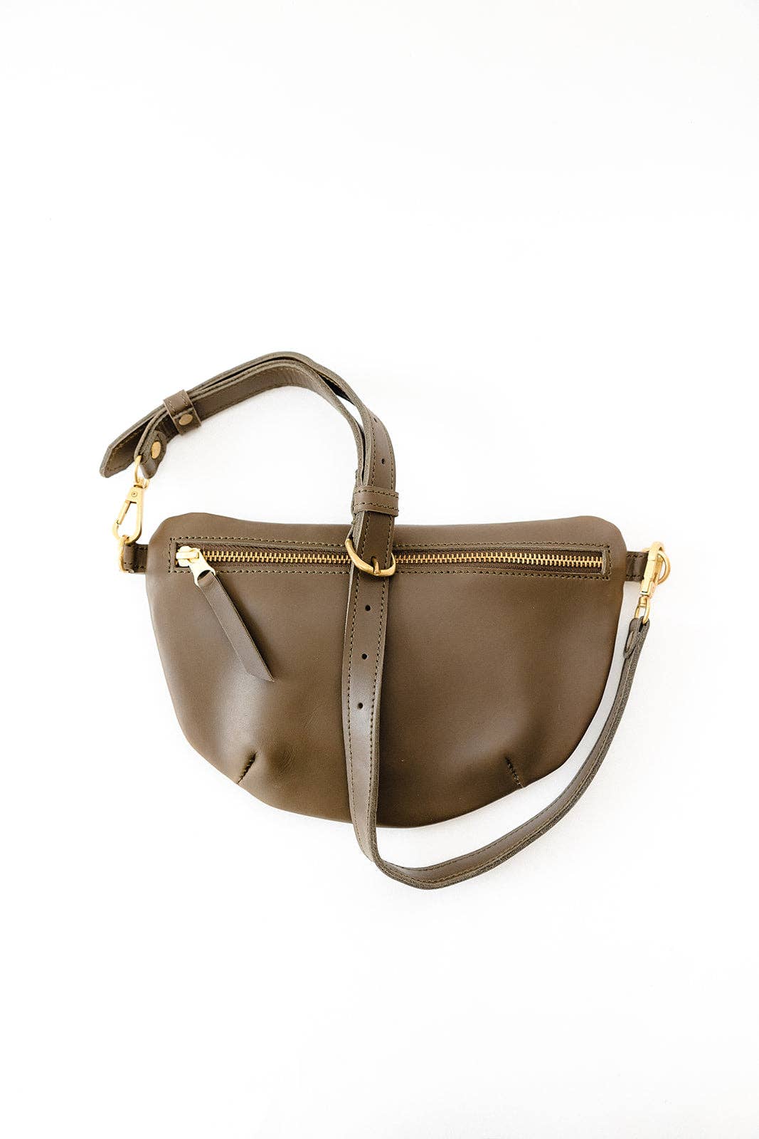 Fair trade and adjustable leather sling bag/fanny pack. Adjust the length to fit your needs. Handcrafted, vegetable tanned leather sling bag made in Kenya with locally and ethically-sourced materials. A portion of sales go to an organization in Tanzania empowering children living on the street.