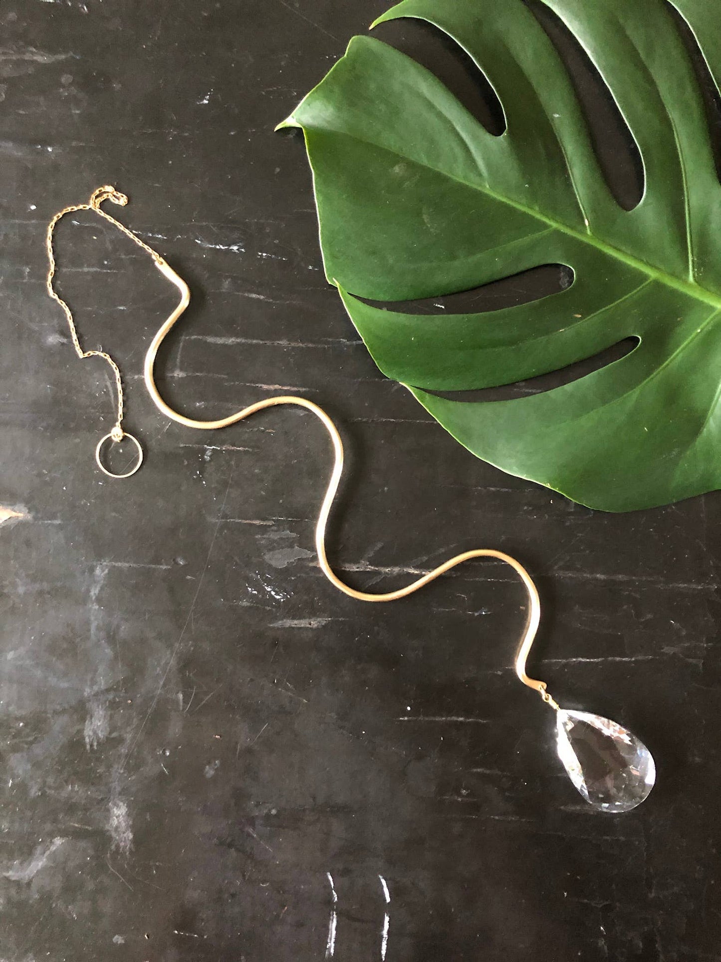 Artisan-crafted sun catcher made from hand forged/hammered brass wire and vintage faceted crystal. Ready to hang by your window where the light pours in and watch the rainbows dance around the room!