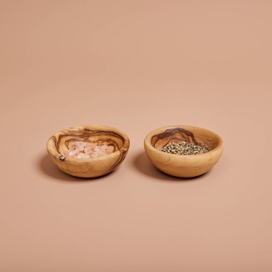 Handcrafted in Tunisia using natural olive wood from the region, these little bowls are hard, durable and non porous. Use them for your salt, pepper, and spices, or to hold sauces and dips. Each piece is unique and becomes even darker, richer and more beautiful in color as it ages.