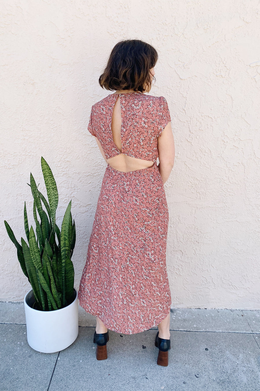 The Bree dress is not only versatile, but she’s a tad bit sexy with a leg slit and cut-out detailing on the front and back. Midi length featuring a tie front and ruffled details. Made in Los Angeles.
