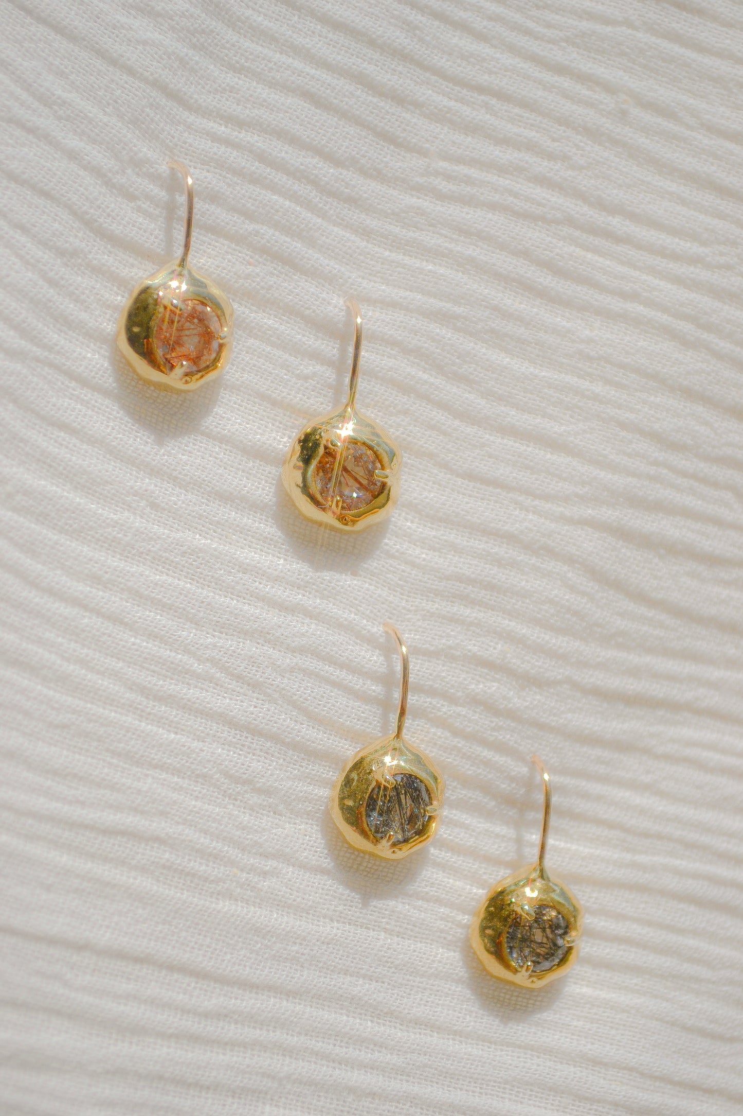 Delicate quartz pendant earrings handmade in northern California by Amanda Hunt. Keep the energy of quartz close to you.