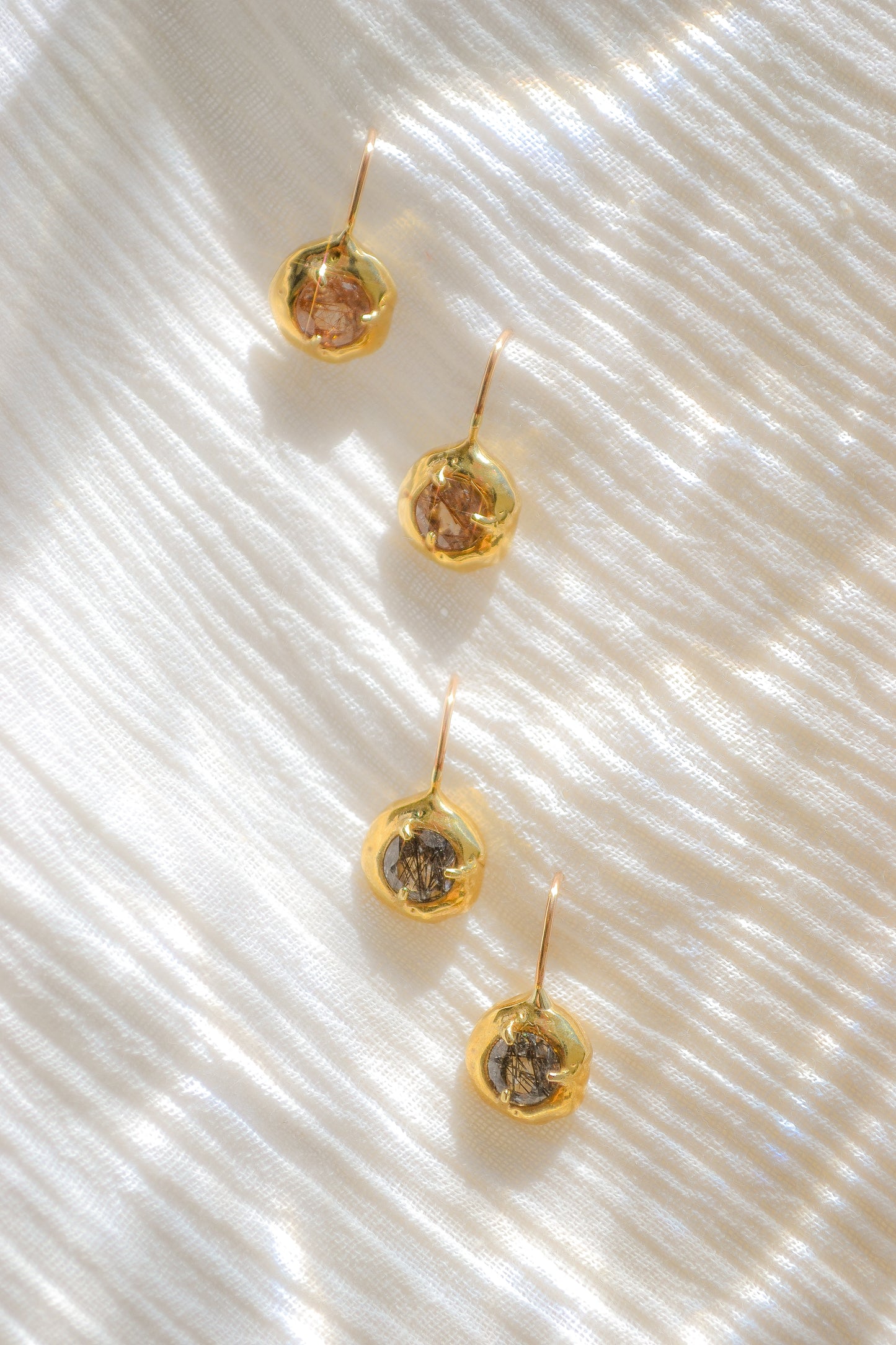 Delicate quartz pendant earrings handmade in northern California by Amanda Hunt. Keep the energy of quartz close to you.