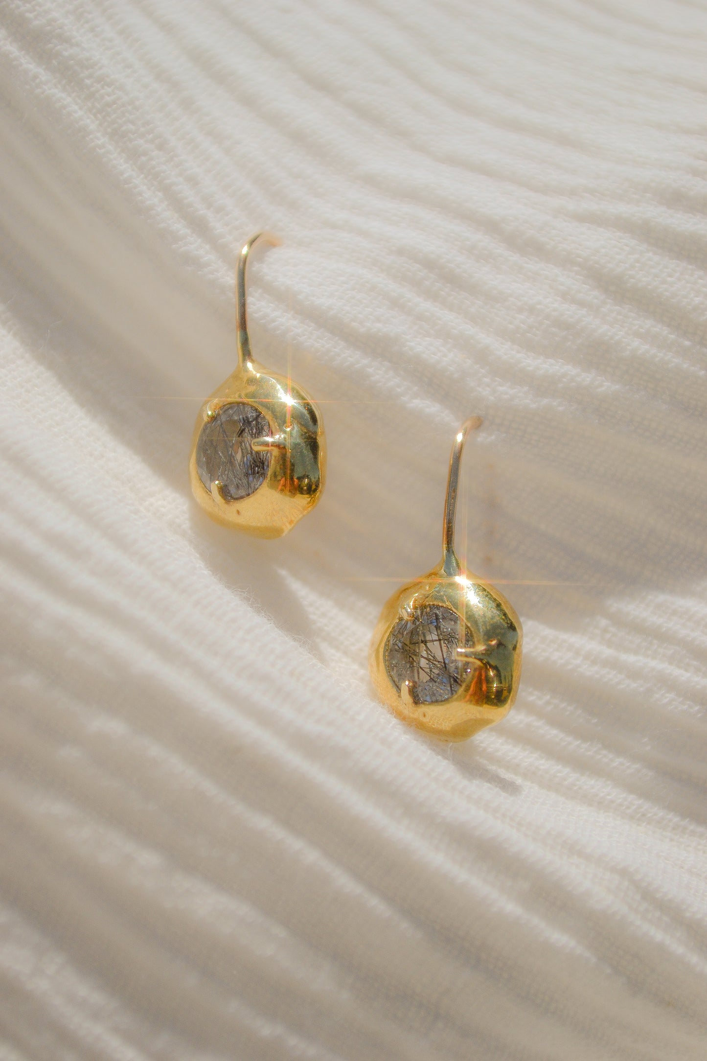 Delicate quartz pendant earrings handmade in northern California by Amanda Hunt. Keep the energy of quartz close to you.