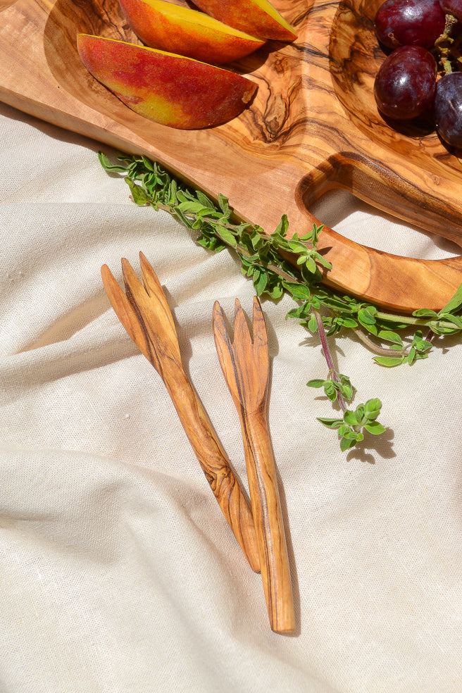 Made by hand in Tunisia with olive trees that had finished producing olives. Cute mini forks can stab, grab and pick up any tasty snack. Perfect for olives, cheese, fruits and more!