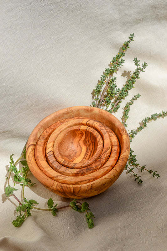 Made by hand in Tunisia with olive trees that had finished producing olives. This set of 4 Olive Wood Nesting Bowls are perfect for prep or service. Use them for separating salt and pepper, spices, herbs, garnish or condiments. 
