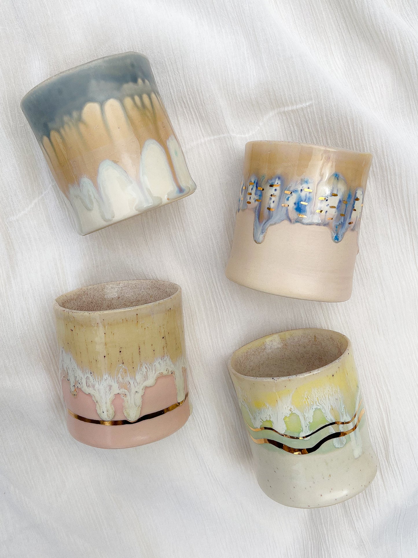 Handmade ceramic tumbler that is just perfect for all of your entertaining needs (including cocktails). Features gold luster accents for all of your celebrations and sure to impress.