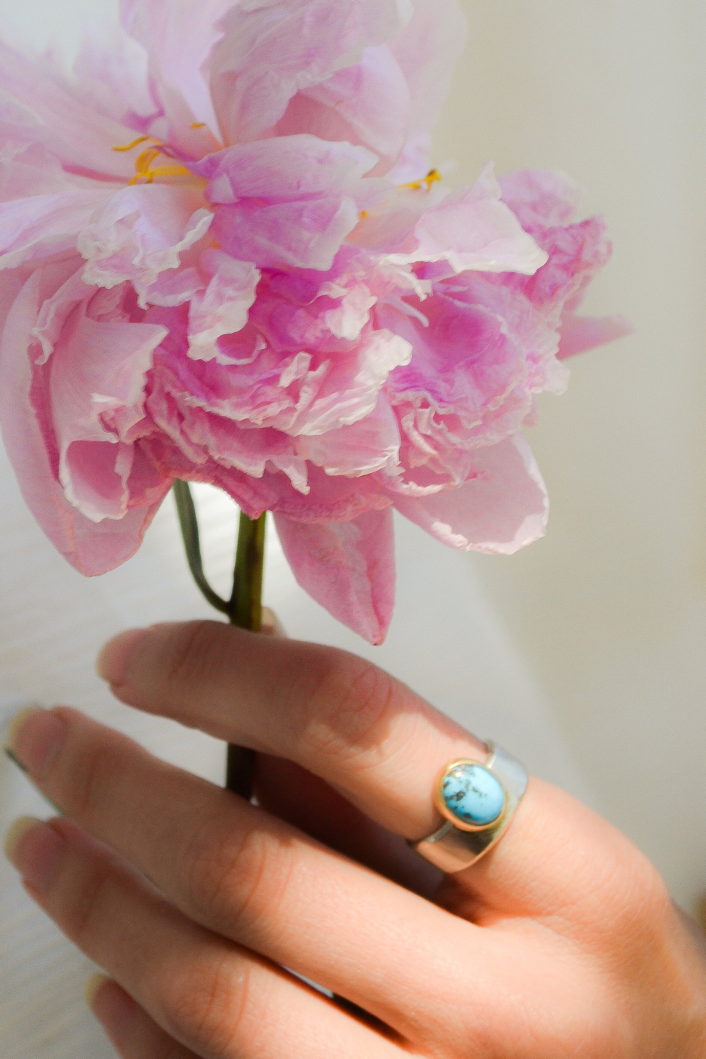 Made by hand in Northern New Mexico using recycled metals and responsibly sourced stones. This ring features a large cabochon Persian Turquoise stone set in a 14k yellow Gold bezel on a wide Sterling Silver band with matte finish. Mesa Ring by Halcyon Jewelry.