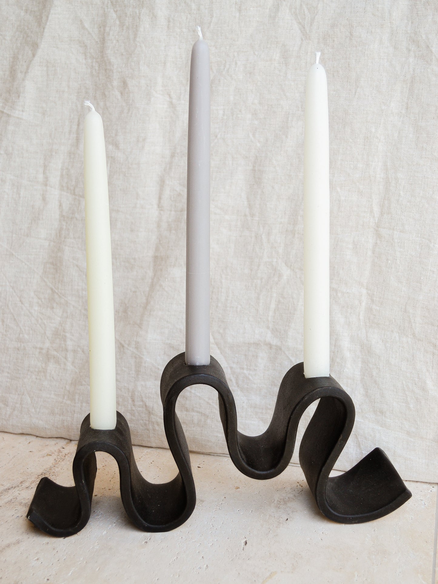 Meet Wyat: A stoneware candelabra with indulgent waves that support candlelight glow for every joyous dance party or intimate conversation over dinner. Handmade in Brooklyn, NY.