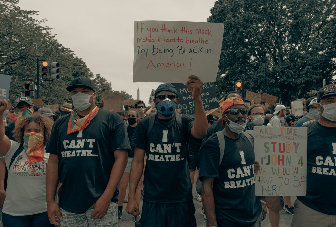 Black activists featuring signs that say "I Can't Breathe" marching in the US in 2020