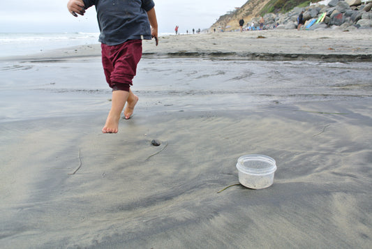 Thread Spun founder's son cleans up trash at the beach and is a future, green surfer.