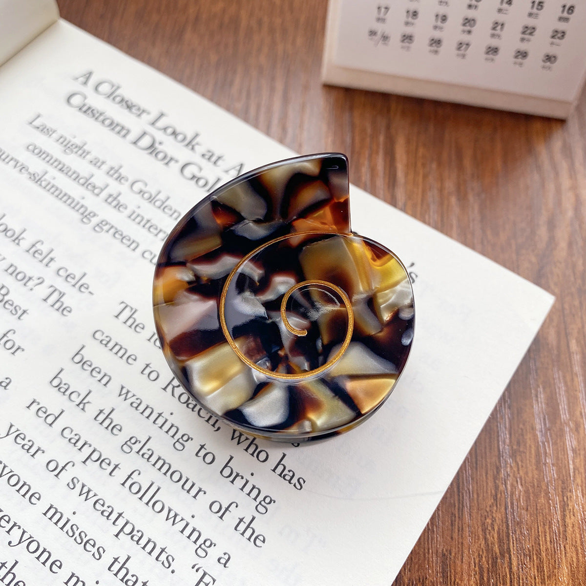 An eco-friendly clip designed to look like a shell hair clip in tortoise color
