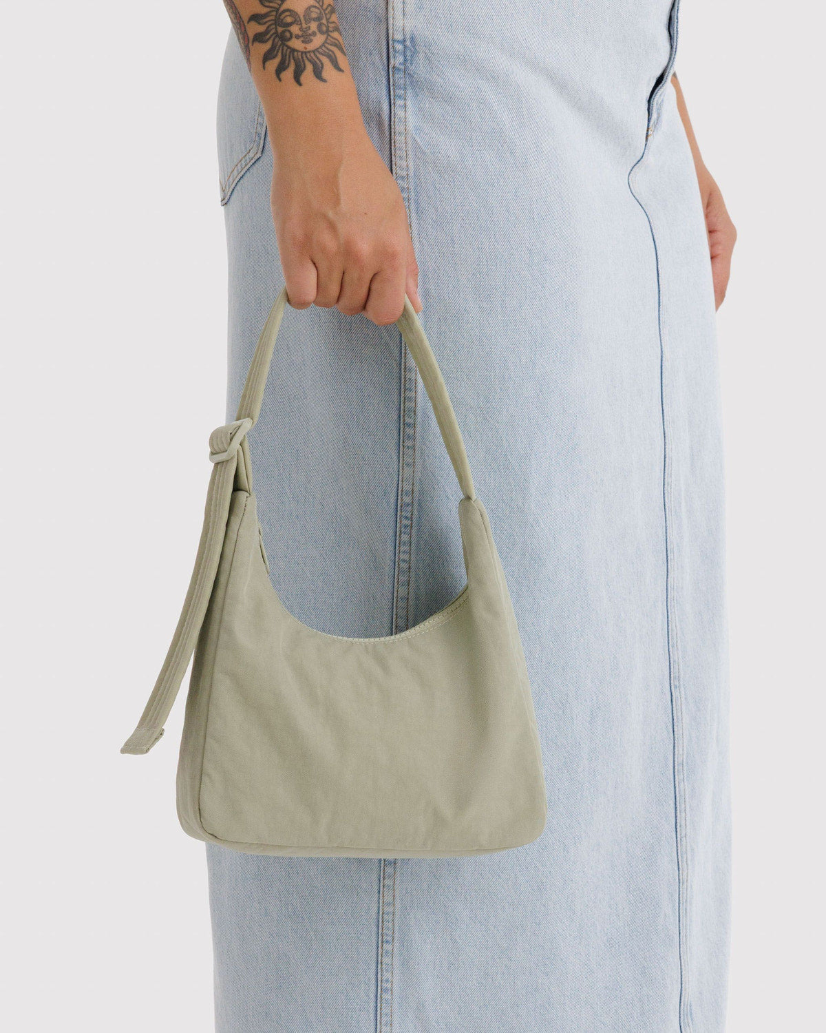 Baggu nylon bag in celadon sold alongside a variety of other Baggu bags and accessories