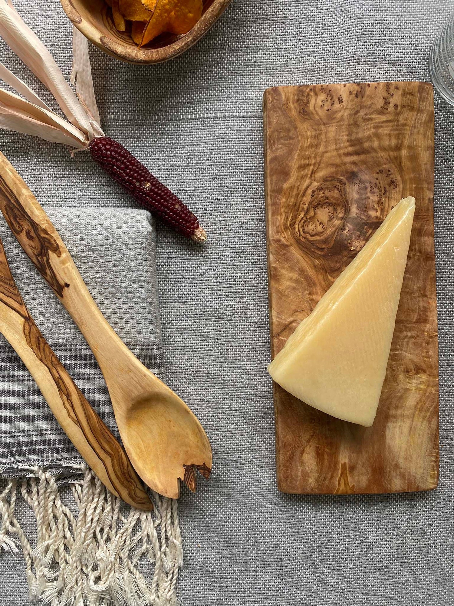 Olive Wood Cheese Board and Utensils sold at Thread Spun. Ethically and sustainably produced goods for your home and kitchen that are as unique as you are. We source pieces to last and create lasting change.