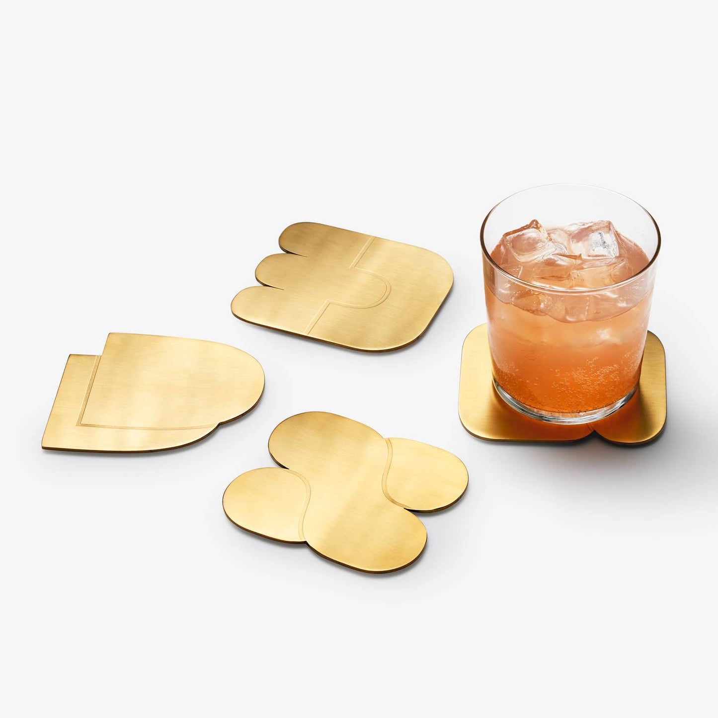 areaware together coasters / Set of four brass-plated coasters uses abstract, interlocking shapes to signify connection and togetherness. The weightiness of the brass ensures none of those sticking-to-your-cup situations when picked up, & designed to protect your surfaces from watermarks and scratches. 