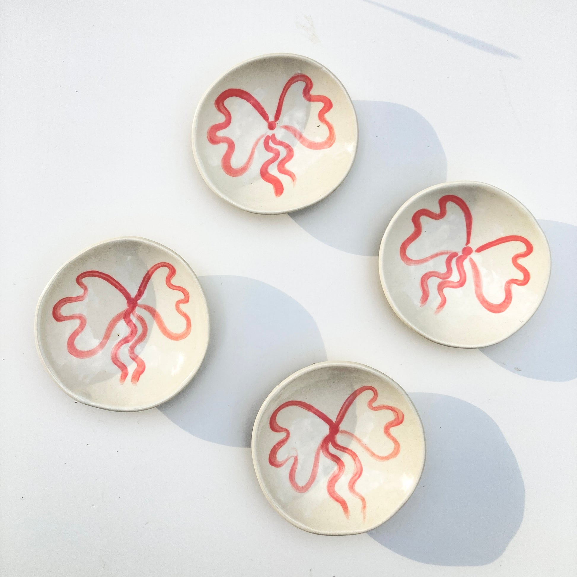 This little ceramic ring dish is made with white stoneware clay that fires warm white / beige color. Each little plate is hand painted with underglaze, all designs are free style painted and never exactly the same. Finally its glazed with clear glaze and signed underneath.

Freely hand painted.Handmade by Alicja in her Vermont studio.
