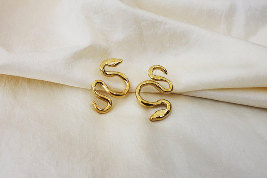 An often maligned species, we find beauty in the powerful serpent. Asymmetrical snake earrings available in brass and sterling silver. All Dea Dia pieces are proudly designed and handmade in Downtown Los Angeles.