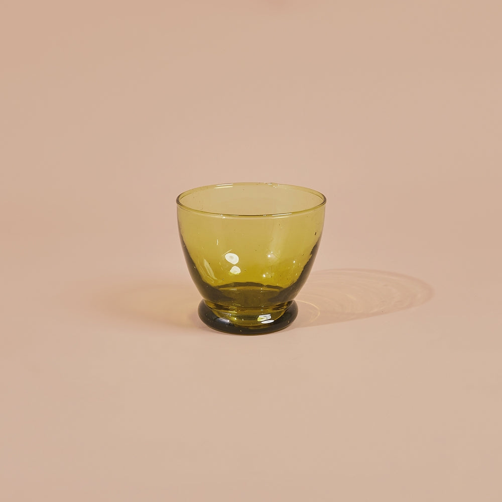 Simple and elegant, the modern glass cup is perfect to serve your favorite drinks or a little desert or even condiments. Handblown in morocco using local recycled beer bottles, giving these materials another life. These glasses are ideal for entertainment or everyday drink ware.