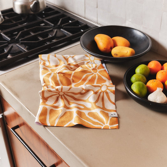 slowtide kitchen towel /This lightweight towel quickly dries and easily absorbs moisture. It also features a loop for hanging and is printed with a reactive dye that prevents fading over time. Made from 100% post-consumer waste, primarily plastic bottles.