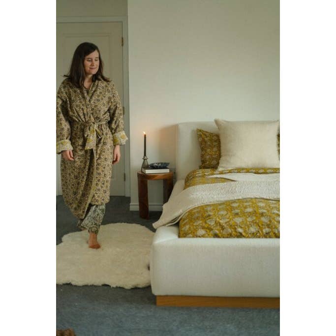 Ethically made sheepskin rug styled in a neutral bedroom