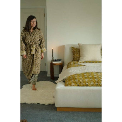 Ethically made sheepskin rug styled in a neutral bedroom