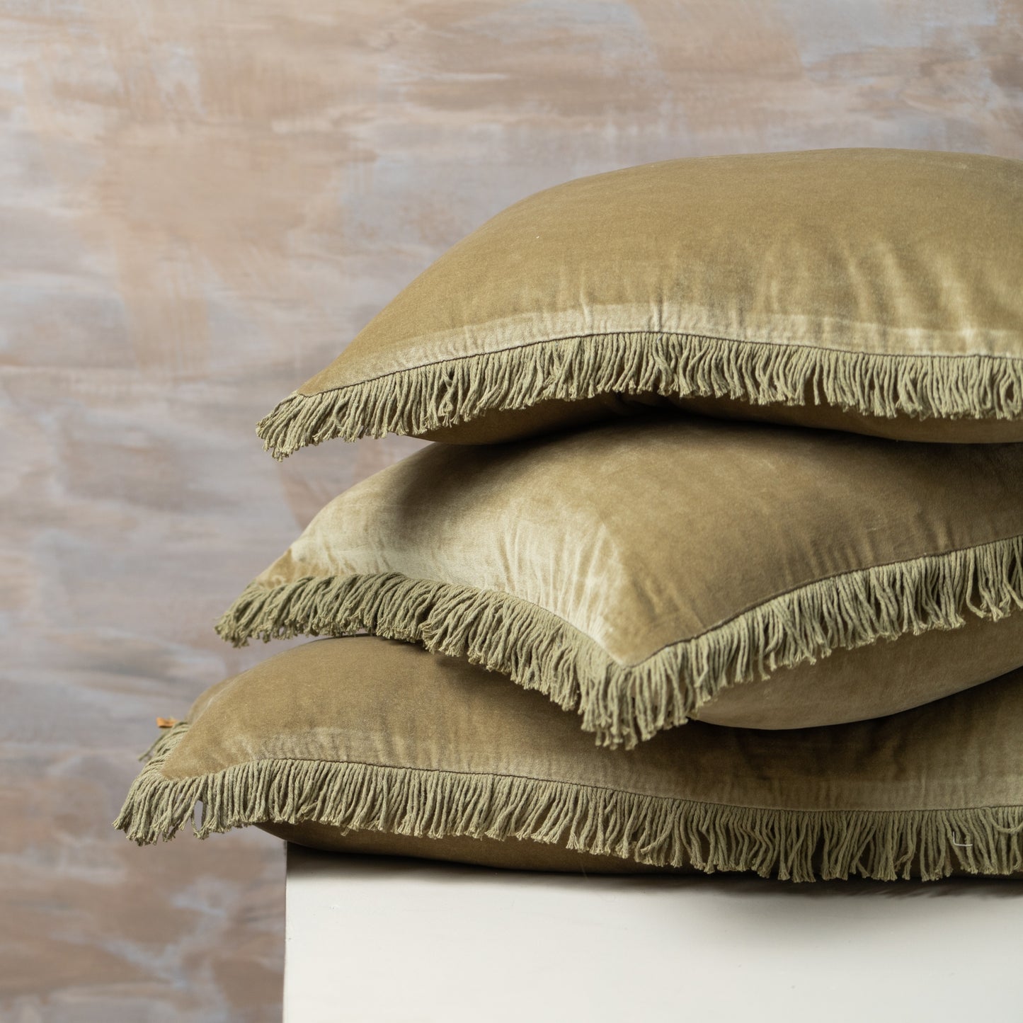 The Olive Velvet Bolster Cushion is the epitome of relaxed, retro styling. With super soft, with vintage wash tones and frayed edge detail, it adds an understated luxury to your room. Made with 100% cotton, measures 15.75" x 35.43".