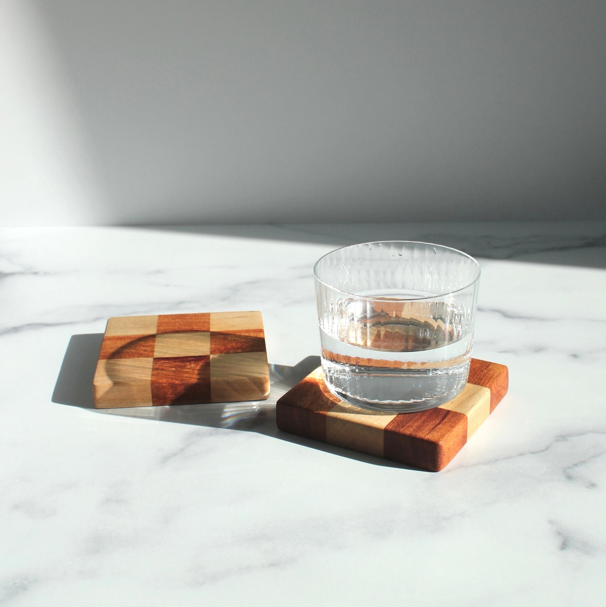 The Chelsea Handcrafted Jumbo Wood Coaster Set offers a unique spin on a traditional checkered design, with a bulkier size that makes them perfect for unconventional spaces where you still want to protect your furniture, like your office or bedroom.&nbsp;