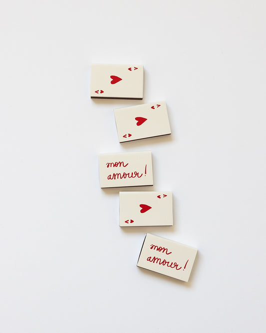 Celebrate love with the "Mon Amour" Matchbox, a tiny gift that means so much. Measuring 2.25" × 1" w, it's the perfect pocket-sized companion for moments of celebration and togetherness.