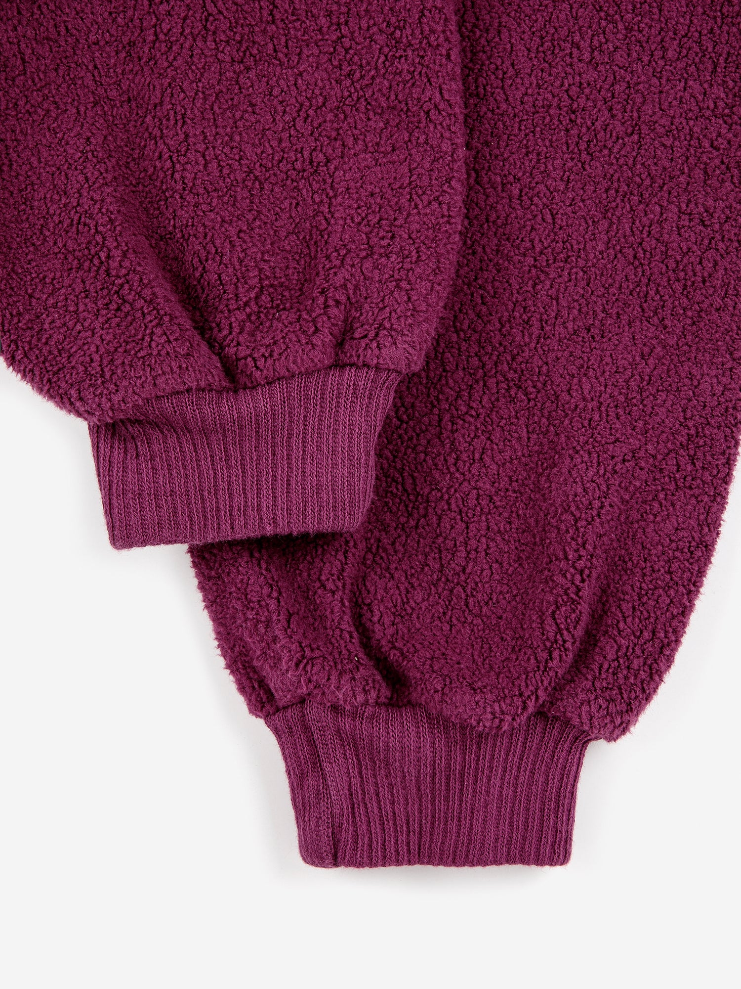B.C. Label Sweatshirt by Bobo Choses. 100% organic cotton purple fleece sweatshirt. Designed with balloon sleeves, dropped shoulder, ribbed mock neck & hems, and a half zipper. It has a loose fit.  Made ethically and sustainably in Portugal for Bobo Choses.