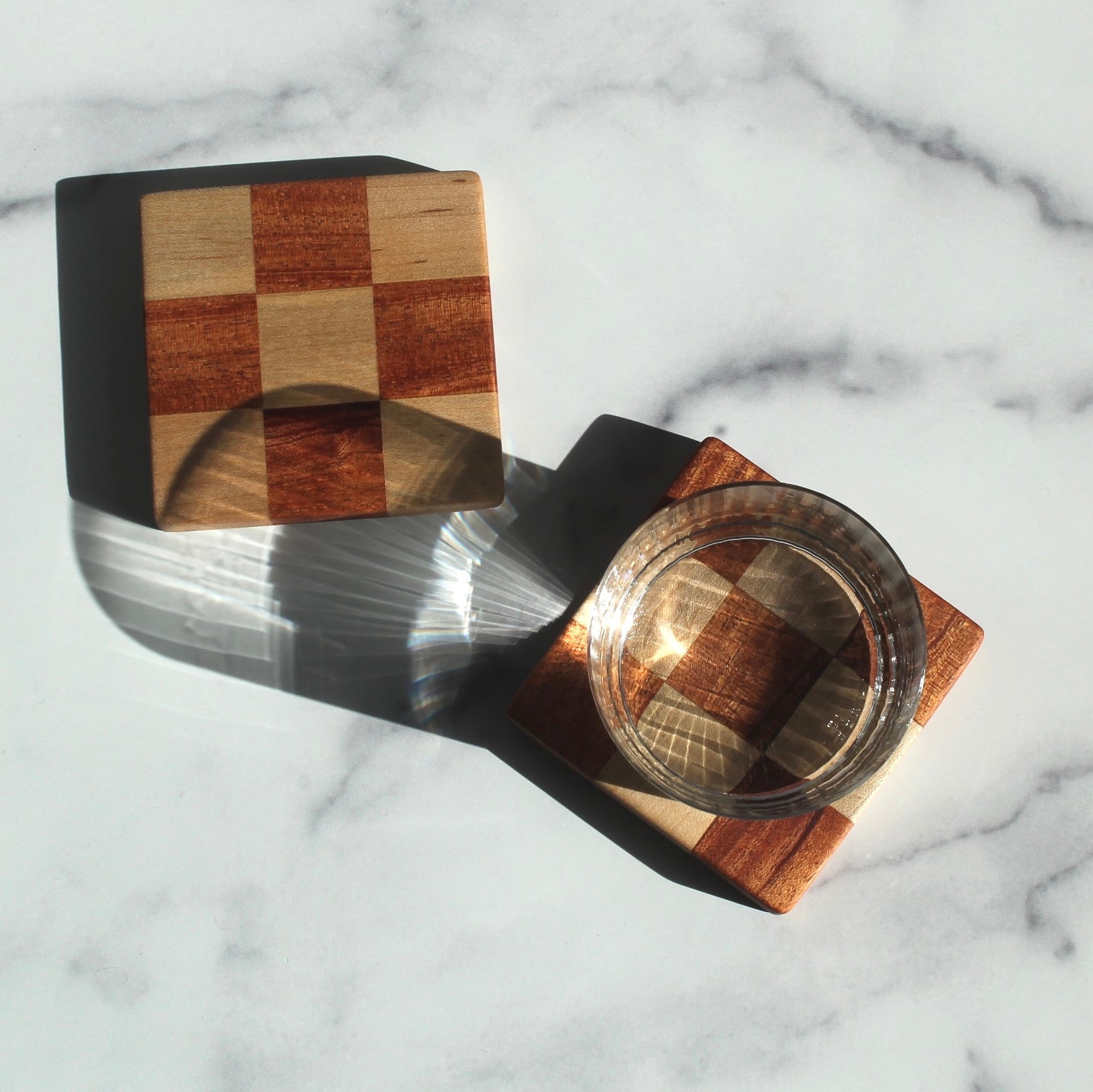 The Chelsea Handcrafted Jumbo Wood Coaster Set offers a unique spin on a traditional checkered design, with a bulkier size that makes them perfect for unconventional spaces where you still want to protect your furniture, like your office or bedroom.&nbsp;