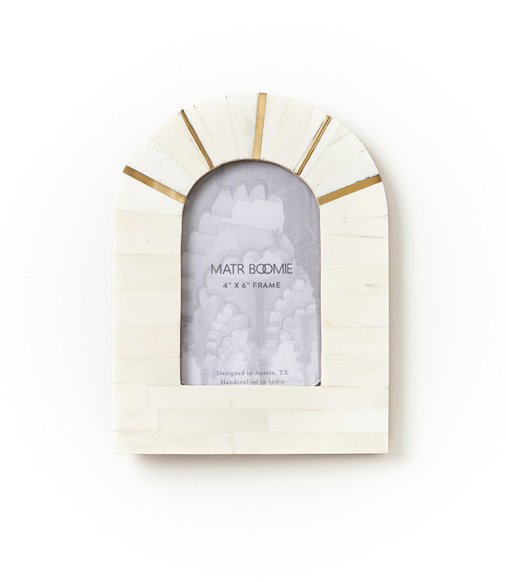 4 x 6. This hand carved picture frame features ethically sourced, cruelty free bone tile in a arch shape with brass accents. For convenient display this photo frame features a one-way table top easel. All of Matr Boomie's collection is handmade, fair trade and sustainable.