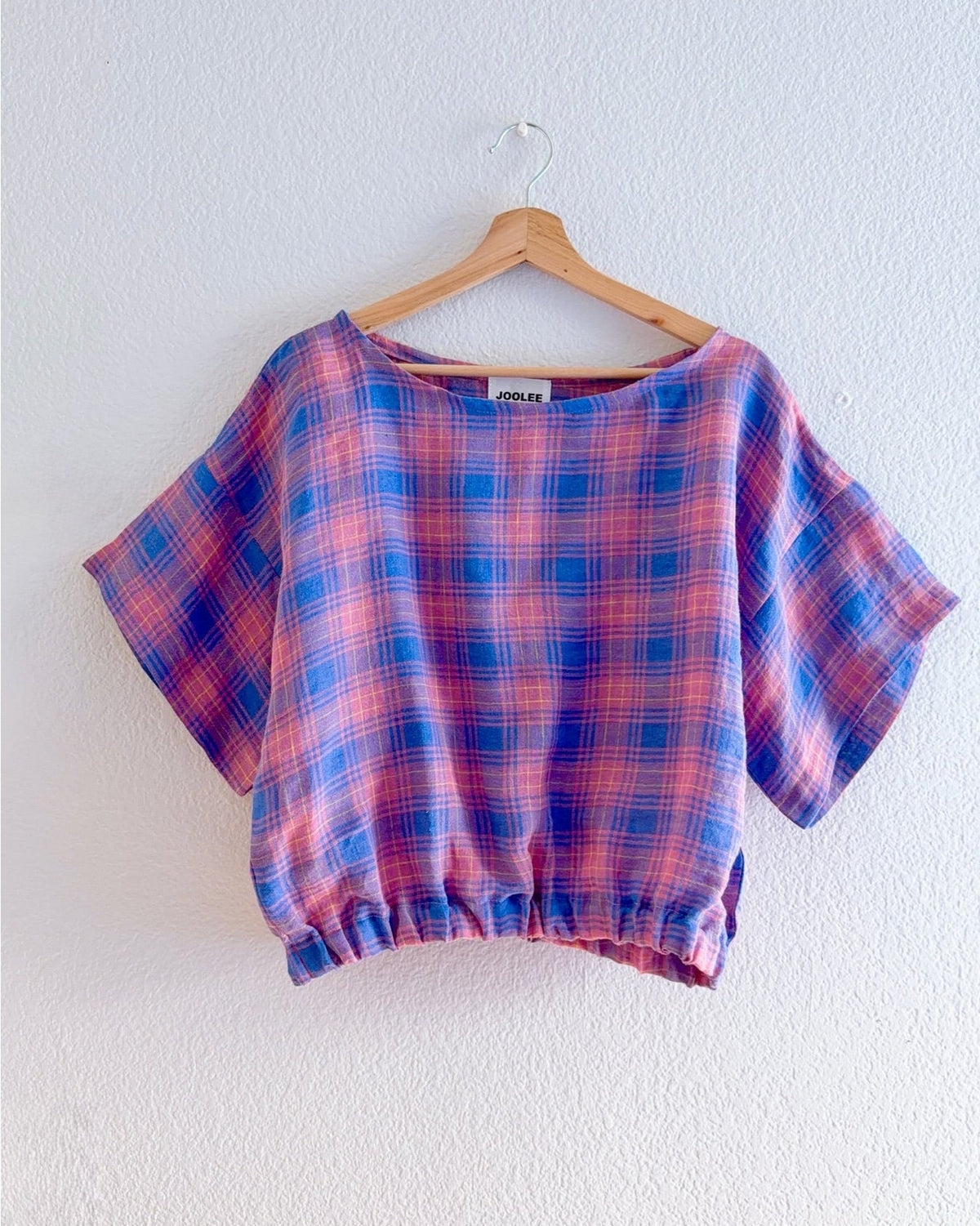 Crafted from 100% high-quality linen, the Lilac Check Top offers breathable comfort for warm weather wear. Features a comfortable waist band and relaxed wide sleeves that move with ease.