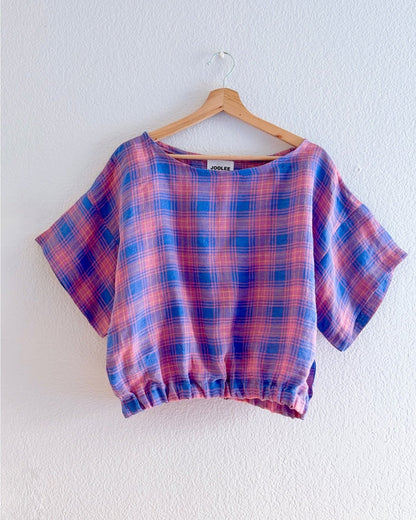 Crafted from 100% high-quality linen, the Lilac Check Top offers breathable comfort for warm weather wear. Features a comfortable waist band and relaxed wide sleeves that move with ease.